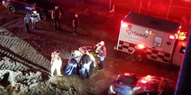 An Atlanta Police officer crashed a gate to get to a motorist whose vehicle fell down an embankment.