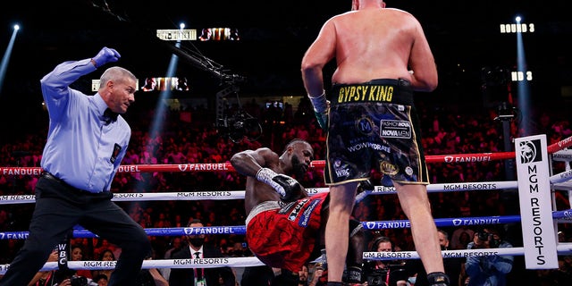 Tyson Fury of England knocks down Deontay Wilder during a heavyweight championship boxing match on Saturday, October 9, 2021 in Las Vegas.