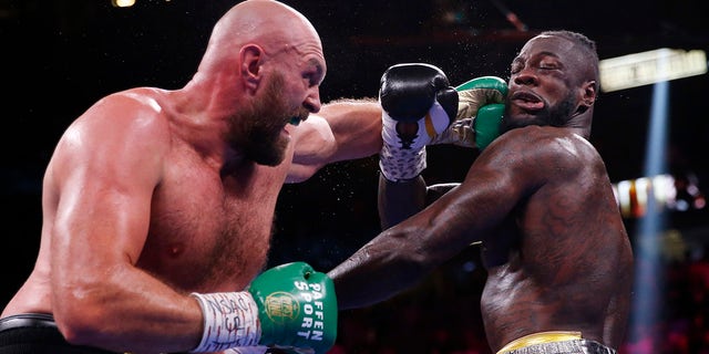 Tyson Fury of England lands a left at Deontay Wilder during a heavyweight championship boxing match on Saturday, October 9, 2021 in Las Vegas.