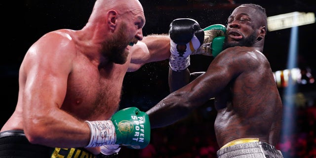 Tyson Fury, of England, lands a left to Deontay Wilder in a heavyweight championship boxing match Saturday, Oct. 9, 2021, in Las Vegas.