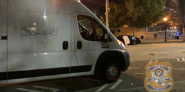 An off-duty officer working parking enforcement was sitting in his patrol vehicle when he was approached by a man who shot a firearm at the officer, striking him in the neck, state investigators said. The officer then shot and killed the suspect.