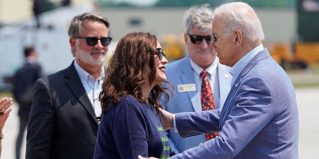 U.S. President Joe Biden greets Michigan Governor Gretchen Whitmer as he arrives in Traverse City, Michigan, U.S., July 3, 2021. 