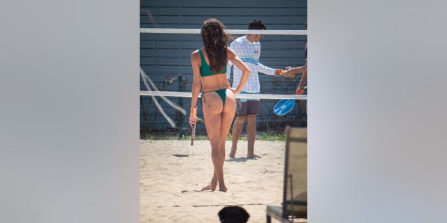 Morgan Brown is seen playing a game of beach tennis with friends during an outing in Puerto Rico.