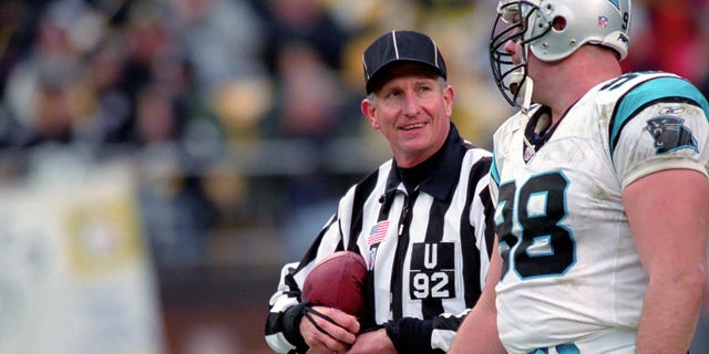 National Football League umpire Carl Madsen talks to defensive lineman Shane Burton #98 of the Carolina Panthers during a game against the Pittsburgh Steelers at Heinz Field on Dec. 15, 2002 in Pittsburgh, Pennsylvania.  