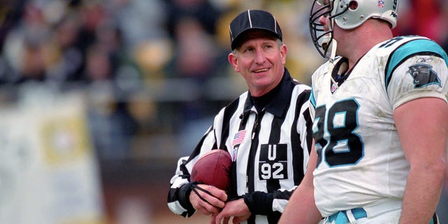 National Football League umpire Carl Madsen talks to defensive lineman Shane Burton #98 of the Carolina Panthers during a game against the Pittsburgh Steelers at Heinz Field on Dec. 15, 2002 in Pittsburgh, Pennsylvania.  