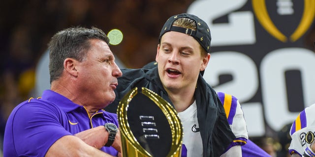 NEW ORLEANS, LA - JANUARY 13: LSU Tigers quarterback Joe Burrow (9) and LSU Tigers head coach Ed Orgeron share a moment on stage before the trophy presentation after winning the CFP National Championship game between the LSU Tigers and Clemson Tigers at the Mercedes-Benz Superdome on January 13, 2020 in New Orleans, LA. (Photo by Ken Murray/Icon Sportswire via Getty Images)