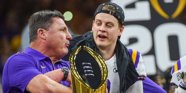 NEW ORLEANS, LA - JANUARY 13: LSU Tigers quarterback Joe Burrow (9) and LSU Tigers head coach Ed Orgeron share a moment on stage before the trophy presentation after winning the CFP National Championship game between the LSU Tigers and Clemson Tigers at the Mercedes-Benz Superdome on January 13, 2020 in New Orleans, LA. (Photo by Ken Murray/Icon Sportswire via Getty Images)