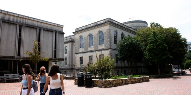 CHAPEL HILL, NC - AUGUST 18: Students walk through the campus of the University of North Carolina at Chapel Hill on August 18, 2020 in Chapel Hill, North Carolina. The school halted in-person classes and reverted back to online courses after a rise in the number of COVID-19 cases over the past week. (Photo by Melissa Sue Gerrits/Getty Images)