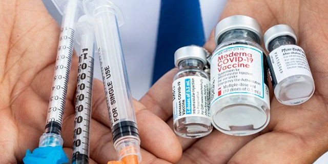 Los Angeles, CA - May 13: Bottles of the three current COVID-19 vaccines from Johnson &amp;amp; Johnson, Moderna and Pfizer, with hypodermics needles, photographed at the COVID-19 vaccination site at Kedren Community Health Center, in Los Angeles, CA, Thursday, May 13, 2021.