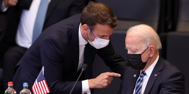 President Biden and French President Emmanuel Macron have a conversation ahead of the NATO summit at the North Atlantic Treaty Organization headquarters in Brussels, on June 14, 2021.