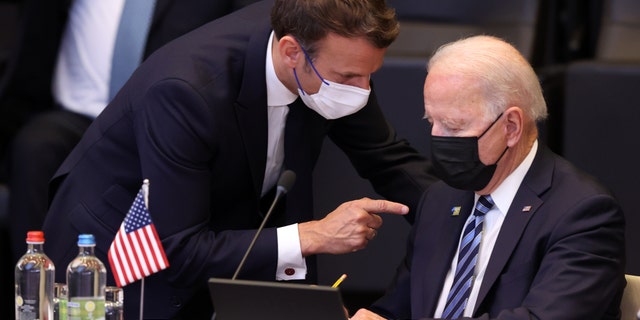 President Biden and French President Emmanuel Macron have a conversation ahead of the NATO summit at the North Atlantic Treaty Organization headquarters in Brussels, June 14, 2021.