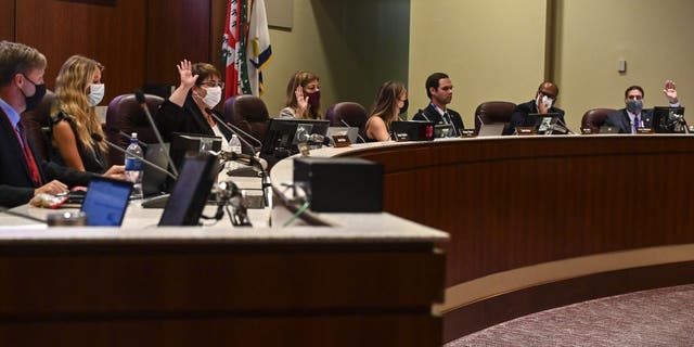 ASHBURN, VA - AUGUST 11: Loudoun County School Board members vote to enact Policy 8040 during a school board meeting at the Loudoun County Public Schools Administration Building on August 11, 2021 in Ashburn, Va.  (Photo by Ricky Carioti/The Washington Post via Getty Images)