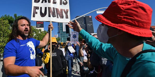 People rally in support of the Netflix transgender walkout and others in support of comedy and free speech, on October 20, 2021 in Los Angeles, California - Netflix bosses braced for an employee walkout and rally in Los Angeles on October 20, 2021 as anger swelled over a new Dave Chappelle comedy special that activists say is harmful to the transgender community. (Photo by Frederic J. BROWN / AFP) (Photo by FREDERIC J. BROWN/AFP via Getty Images)