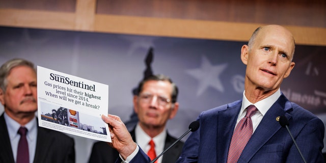 WASHINGTON, DC - OCTOBER 27: Sen. Rick Scott (R-FL) holds up an article from the Sun Sentinel as he speaks alongside other Republican Senators during a press conference on rising gas an energy prices at the U.S. Capitol on October 27, 2021 in Washington, DC. Republicans are placing blame on the Biden Administration for the quickly rising gas prices this year as predictions estimate that heating costs this winter will rise significantly as well. (Photo by Samuel Corum/Getty Images)