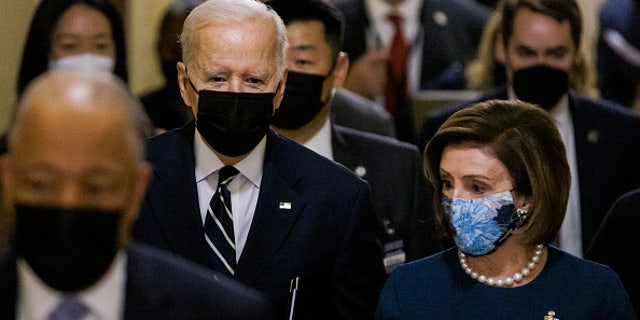 WASHINGTON, DC - OCTOBER 28: U.S. President Joe Biden walks into the U.S. Capitol building with Speaker of the House Nancy Pelosi (D-CA) for a meeting with House Democrats on the continued negotiations over the domestic spending Bills before the President departs for Europe on October 28, 2021 in Washington, DC. President Biden is heading to Rome where he will meet with leaders from the G20 as well as the Pope in the Vatican as Democrats are continuing internal negotiations about his administration's social policy spending bill. (Photo by Samuel Corum/Getty Images)