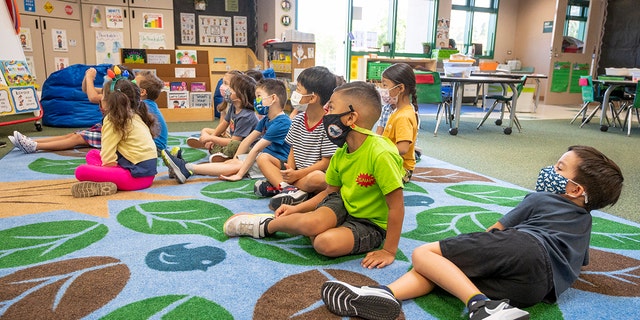 Students listen to their teacher during their first day of  transitional kindergarten class at Tustin Ranch Elementary School in Tustin, CA on Wednesday, August 11, 2021. 