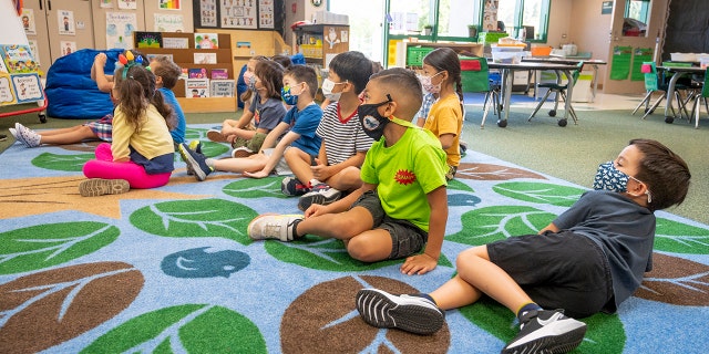 Students listen to their teacher during their first day of  transitional kindergarten class at Tustin Ranch Elementary School in Tustin, CA on Wednesday, August 11, 2021. 