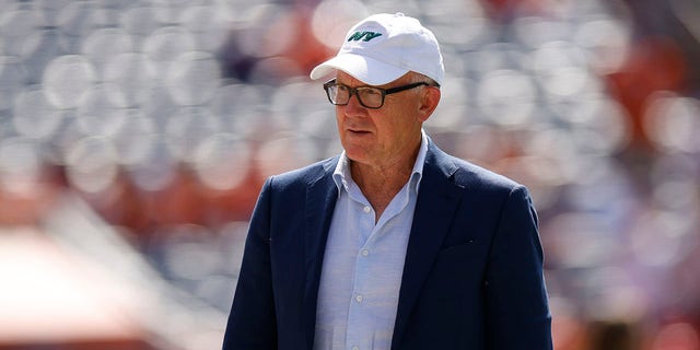 New York Jets owner Woody Johnson on the field before the game against Denver Broncos at Empower Field At Mile High on Sept. 26, 2021 in Denver, Colorado. 
