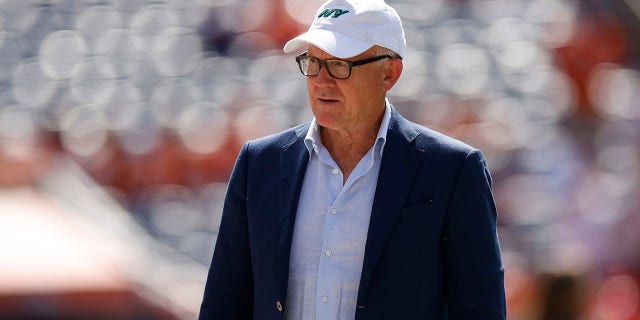 New York Jets owner Woody Johnson on the field before the game against Denver Broncos at Empower Field At Mile High on Sept. 26, 2021 in Denver, Colorado. 