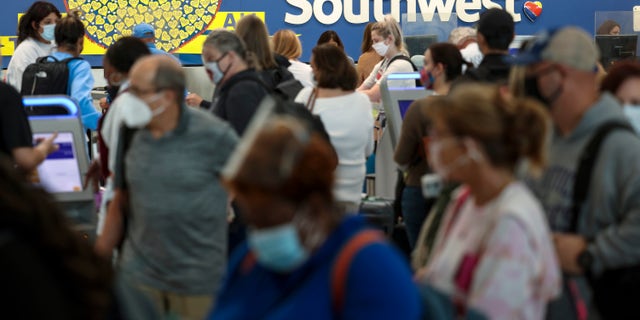 BALTIMORE, MARYLAND - OCTOBER 11: Travelers wait to check in at the Southwest Airlines ticketing counter at Baltimore Washington International Thurgood Marshall Airport on October 11, 2021 in Baltimore, Maryland. Southwest Airlines is working to catch up on a backlog after canceling hundreds of flights over the weekend, blaming air traffic control issues and weather. (Photo by Kevin Dietsch/Getty Images)