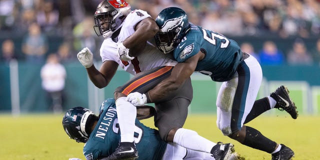 Genard Avery #58 and Steven Nelson #3 of the Philadelphia Eagles tackle Leonard Fournette #7 of the Tampa Bay Buccaneers at Lincoln Financial Field on Oct. 14, 2021 in Philadelphia, Pennsylvania.