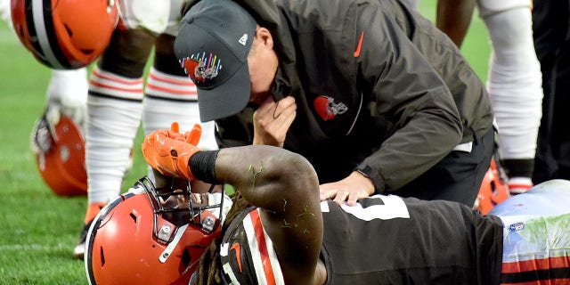 Kareem Hunt #27 of the Cleveland Browns is tended to by team medical personnel after an injury during the fourth quarter against the Arizona Cardinals at FirstEnergy Stadium on October 17, 2021 in Cleveland, Ohio.