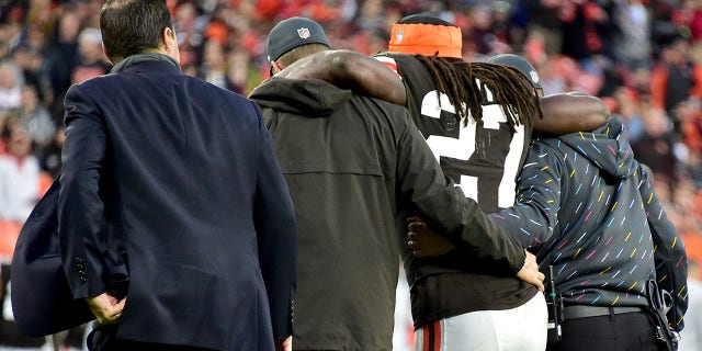 Kareem Hunt #27 of the Cleveland Browns is helped off the field by team medical personnel after an injury during the fourth quarter against the Arizona Cardinals at FirstEnergy Stadium on October 17, 2021 in Cleveland, Ohio.