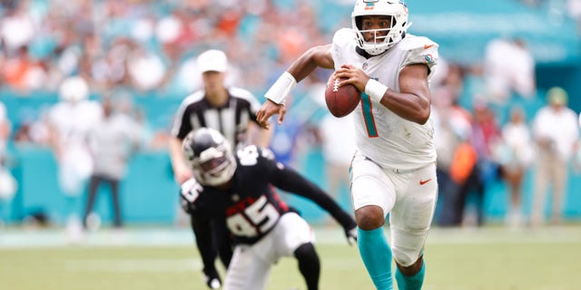MIAMI GARDENS, FLORIDA - OCTOBER 24: Tua Tagovailoa #1 of the Miami Dolphins scrambles with the ball against the Atlanta Falcons during the fourth quarter at Hard Rock Stadium on October 24, 2021 in Miami Gardens, Florida.