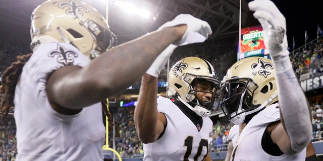 SEATTLE, WASHINGTON - OCTOBER 25: Alvin Kamara #41 of the New Orleans Saints celebrates a touchdown with Tre'Quan Smith #10 and Marquez Callaway #1 during the first half against the Seattle Seahawks at Lumen Field on October 25, 2021 in Seattle, Washington. (Photo by Steph Chambers/Getty Images)