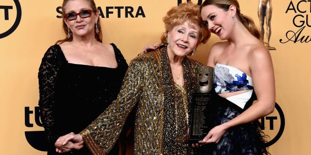 (L-R) Actress Carrie Fisher, honoree Debbie Reynolds and Billie Lourd pose in the press room at the 21st Annual Screen Actors Guild Awards at The Shrine Auditorium on January 25, 2015, in Los Angeles, California.