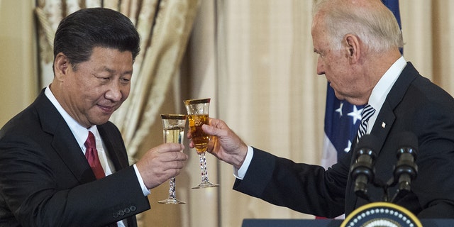Next, Vice President Joe Biden and Chinese President Xi Jinping toast at a State Luncheon for China hosted by US Secretary of State John Kerry on September 25, 2015 at the State Department in Washington, DC.  AFP PHOTO / PAUL J. RICHARDS (Photo credit to read PAUL J. RICHARDS / AFP via Getty Images)
