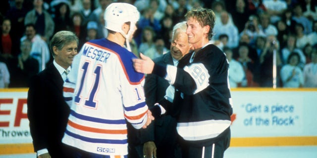 Mark Messier #11 of the Edmonton Oilers congratulates Wayne Gretzky #99 of the Los Angeles Kings after he scored his 1851st career NHL point on October 15, 1989 at the Northlands Coliseum in Edmonton, Alberta, Canada.