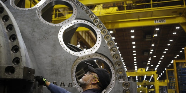 A worker stands on the assembly line for gas turbines at the General Electric Co. (GE) energy plant in Greenville, South Carolina, U.S., on Tuesday, Jan. 10, 2017. General Electric Co. is scheduled to release earnings figures on January 20. Photographer: Luke Sharrett/Bloomberg via Getty Images