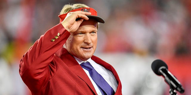 John Gruden puts on his Bucs hat prior to his 