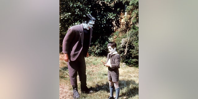 American actors Fred Gwynne (1926-1993) as Herman Munster and Butch Patrick as Eddie Munster in the TV comedy horror series 'The Munsters', circa 1965.