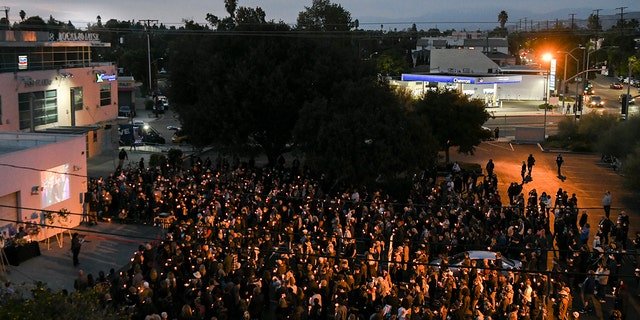 Mourners attend a candlelight vigil for Halyna Hutchins at IATSE West Coast Office on Oct. 24, 2021, in Burbank, California.
