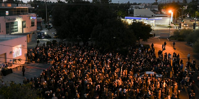 Mourners attend a candlelight vigil for Halyna Hutchins at IATSE West Coast Office on Oct. 24, 2021 in Burbank, California.