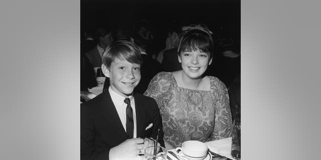 American actor Bill Mumy and British actor Angela Cartwright, stars of the television show 'Lost In Space,' attend the Spotlighters Teen Awards dinner, circa 1966.