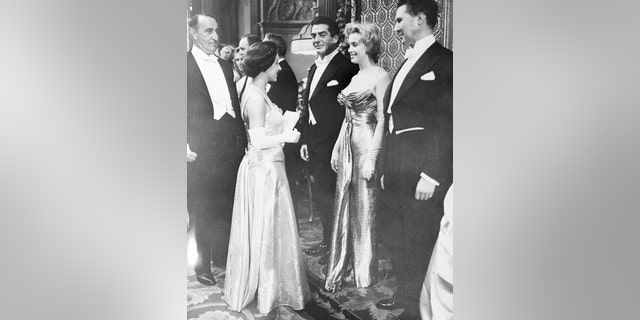 Britain's Princess Margaret (L) chats with Marilyn Monroe before a royal film performance.