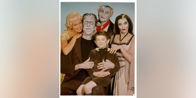 Beverley Owen, Al Lewis and Butch Patrick along with Fred Gwynne and Yvonne De Carlo of the Munster family in a publicity photograph from the television series 'The Munsters', circa 1964. 