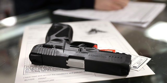 A customer purchases a gun at Freddie Bear Sports on April 08, 2021 in Tinley Park, Illinois. 