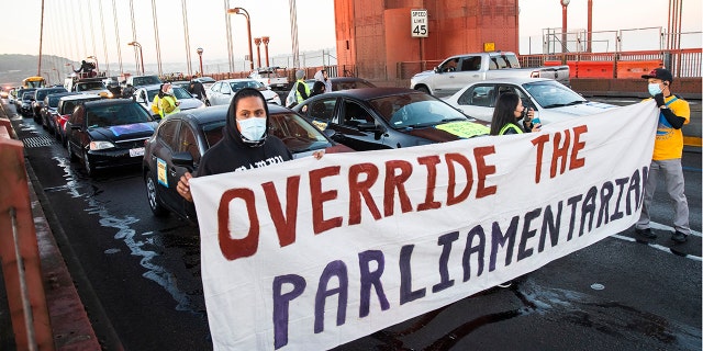 SAN FRANCISCO, CA - SEPTEMBER 30: Protesters block northbound traffic on the Golden Gate Bridge in San Francisco, CA. Thursday, September 30, 2021 during a demonstration demanding Congress grant a pathway to citizenship for the country's 11 million undocumented people. (Jessica Christian/The San Francisco Chronicle via Getty Images)