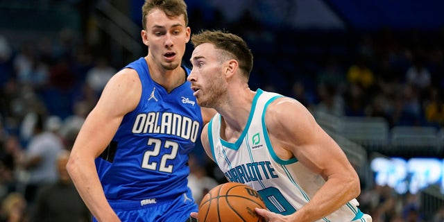 Charlotte Hornets' Gordon Hayward, right, moves to the basket against Orlando Magic's Franz Wagner (22) during the first half of an NBA basketball game, Wednesday, Oct. 27, 2021. , in Orlando, Florida.