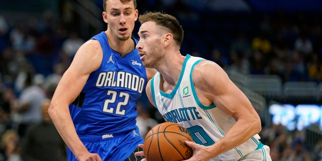 Charlotte Hornets' Gordon Hayward, right, moves to the basket against Orlando Magic's Franz Wagner (22) during the first half of an NBA basketball game, Wednesday, Oct. 27, 2021. , in Orlando, Florida.