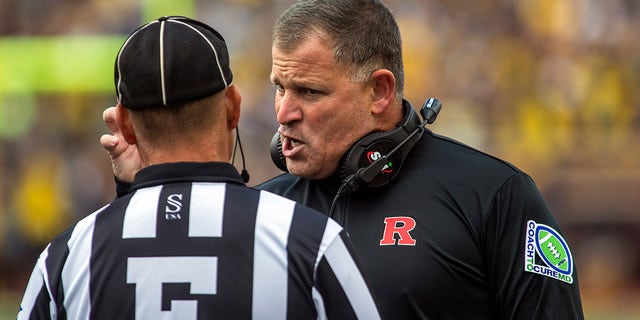 Rutgers head coach Greg Schiano chats with a sideline official in the first quarter of an NCAA college football game against Michigan in Ann Arbor, Mich. On Saturday, September 25, 2021.