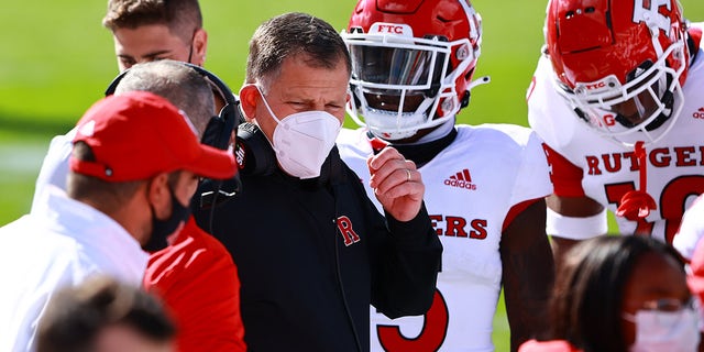 Rutgers Scarlet Knights head coach Greg Schiano chats with his team during a game against the Michigan State Spartans at Spartan Stadium on October 24, 2020 in East Lansing, Michigan.