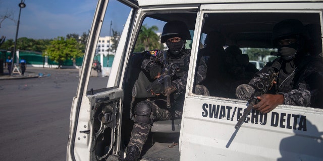 Armed forces secure the area where the Haiti's Prime Minister Ariel Henry placed a bouquet of flowers in front of independence hero Jean Jacques Dessalines memorial in Port-au-Prince, Haiti on Sunday.