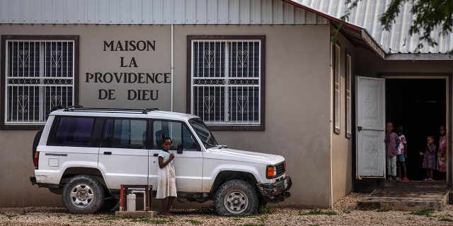 Children stand in the courtyard of the Maison La Providence de Dieu orphanage it Ganthier, Croix-des-Bouquets, Haiti, on Sunday where a gang abducted 17 missionaries from a U.S.-based organization. 