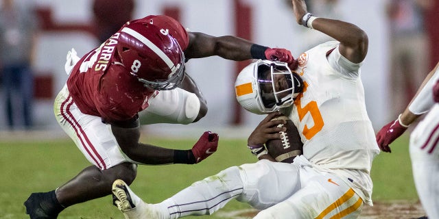 Alabama defensive back Jordan Battle (9) tackles Tennessee quarterback Hendon Hooker (5) during the second half of an NCAA college football game, Saturday, Oct. 23, 2021, in Tuscaloosa, Ala.