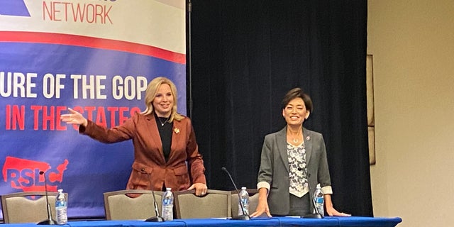 Reps. Ashley Hinson, R-Iowa, and Young Kim, R-Calif., gesture as they take the stage at a Republican State Leadership Committee (RSLC) event on Wednesday, Oct. 20, 2021. (Tyler Olson/Fox News)